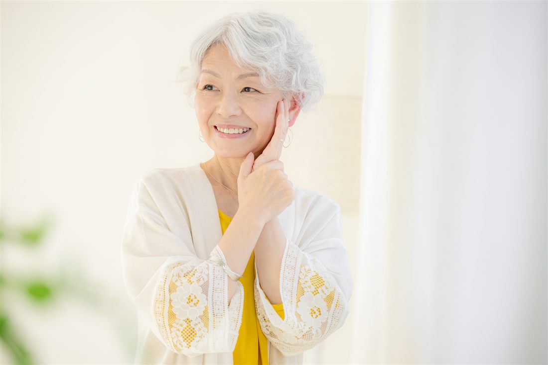 明るい室内で微笑むシニア女性